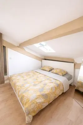 a bedroom with a bed in a room at Le Grand Ruisseau in Nice