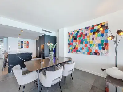 a dining room with a table and chairs and a painting at Nestor&Jeeves - LE ROYAL LUXEMBOURG - Sea view - Terrace in Nice