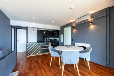 a kitchen and living room with a table and chairs at 73 CORNE D OR - Toit Terrasse - Vue Mer Panoramique - Jaccuzzi in Villefranche-sur-Mer