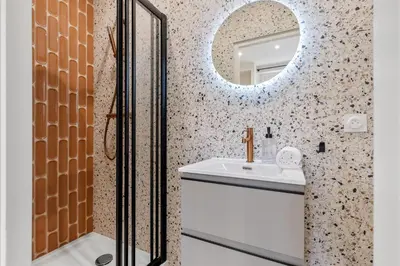 a bathroom with a sink and a mirror at RIVIERA COZY - Place Massena in Nice
