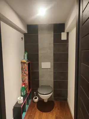 a bathroom with a toilet with a black wall at Villa moderne avec piscine vue mer à Nice Bellet in Nice
