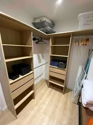 a walk in closet with wooden shelves at Loft - 