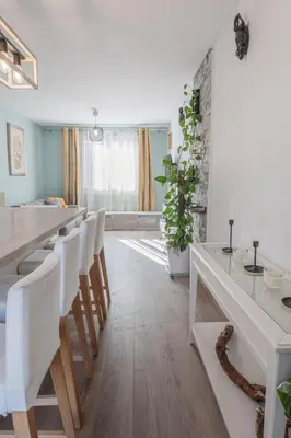 a white kitchen with a long table and white chairs at Beautiful 3 room apartment - Parking -Centre -Tram in Nice