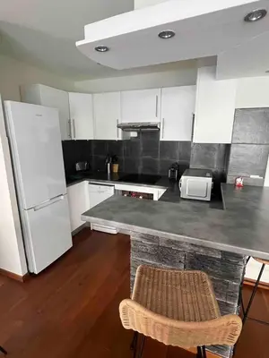 a kitchen with a counter and a white refrigerator at Beautiful apartment - Centre in Cagnes-sur-Mer