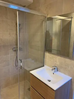 a bathroom with a sink and a glass shower at Massena : Hyper Centre Studio 2p in Nice