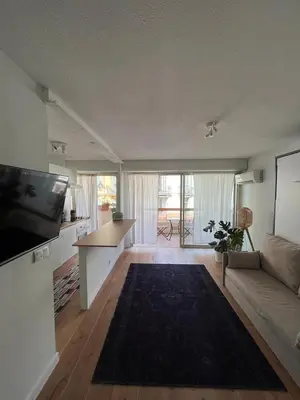a living room with a couch and a flat screen tv at Beautiful studio - Terrace in Nice