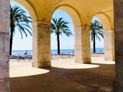an archway with palm trees in front of the ocean at #30 Old Town, Castle panoramic View / Terrace & AC in Nice