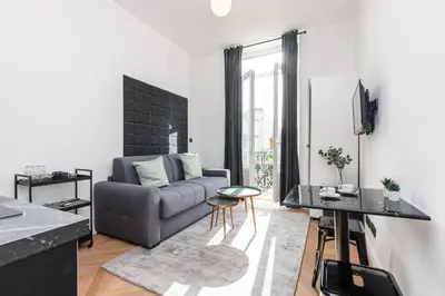a living room with a couch and a table at 7 FOCH 202 - Studio contemporain en plein coeur de Nice - climatisation in Nice