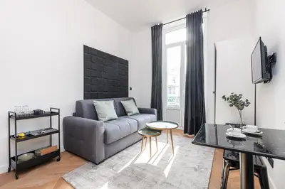 a living room with a couch and a table at 7 FOCH 202 - Studio contemporain en plein coeur de Nice - climatisation in Nice