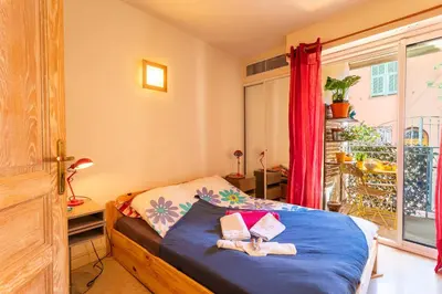 a bedroom with a bed with a teddy bear on it at LA CASA AP4409 By Riviera Holiday Homes in Villefranche-sur-Mer
