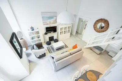 a living room with a couch and a fireplace at La Petite Chaise Bleue Appartement classe 3 etoiles in Nice