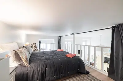 a bedroom with a bed on a balcony at La Petite Chaise Bleue Appartement classe 3 etoiles in Nice