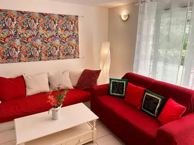 a living room with red couches and a painting at Suite DES DOMES FSHH in Nice