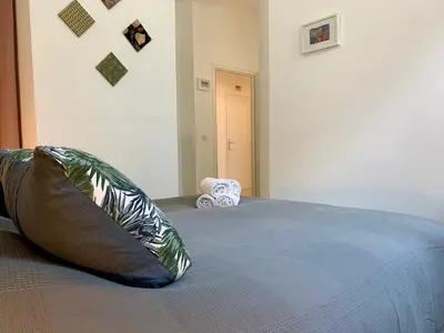 a bedroom with a bed with a pillow on it at ApartHotel Riviera - MAISON DU GRAND SUD - Confortable petit 3 pièces - Promenade des Anglais in Nice