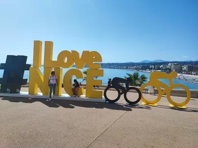 a group of people standing next to a large sign with bikes at Beau studio meublé hyper centre Nice in Nice