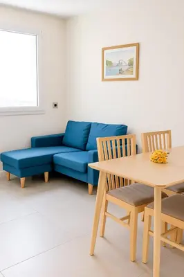 a living room with a blue couch and a table at 1 bedroom Brand new flat in the heart of Nice quartier des Musiciens in Nice