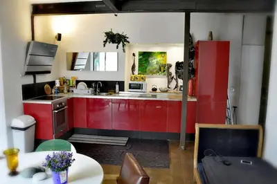 a kitchen with red cabinets and a red refrigerator at Nice - Stylish apartment downtown in Nice