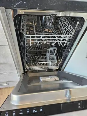 a dishwasher with a drying rack inside of it at Le plein ciel Studio in Nice