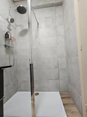 a shower with a glass door in a bathroom at Le plein ciel Studio in Nice