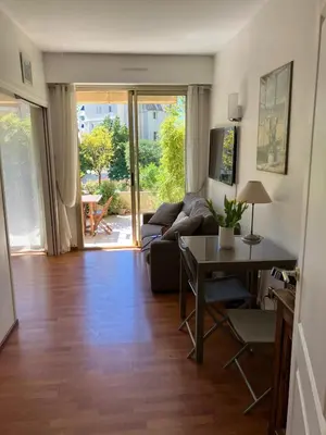 a living room with a couch and a table at Beaulieu in Beaulieu-sur-Mer