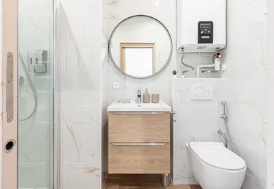 a bathroom with a sink and a mirror at Beau deux pièces cozy avec terrasse n11 in Nice