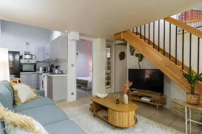 a living room with a blue couch and a television at 3 pièces au cœur du carré d'or in Nice