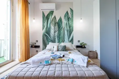 a bedroom with a large bed with a large mural on the wall at MY CASA - GUIDONI - Superb City Center Suite Apartment in Nice