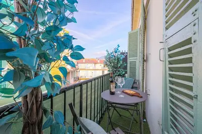 a balcony with a table with a bottle of wine at MY CASA - GUIDONI - Superb City Center Suite Apartment in Nice