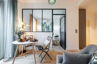 a living room with a table and chairs at MY CASA - GUIDONI - Superb City Center Suite Apartment in Nice