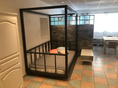 a room with a bunk bed with a table at Appartement Nice proche de Monaco in Nice