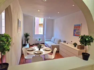 a living room with a table and a couch at Sublime appartement 4P classé dans le Vieux-Nice in Nice