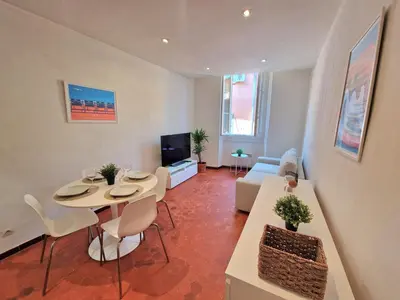 a living room with a table and a couch at Sublime appartement 4P classé dans le Vieux-Nice in Nice