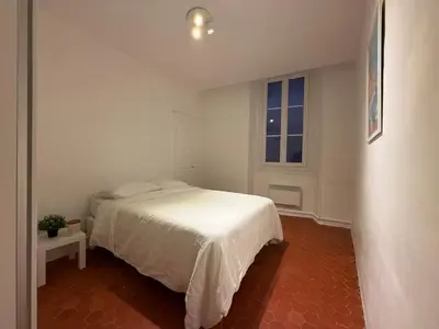 a white bedroom with a bed and a window at Sublime appartement 4P classé dans le Vieux-Nice in Nice