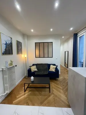 a living room with a couch and a table at Appart Cosy, Proche Gare in Nice