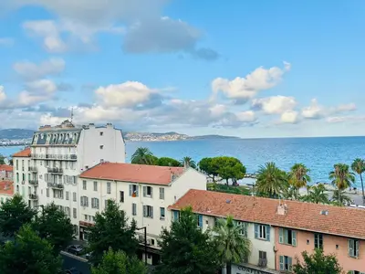 a view of a building and the ocean at Cote d’Azur Charm, Studio Apartment with panoramic seaview in Nice in Nice