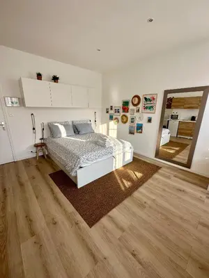 a bedroom with a bed and a large mirror at Royal Studio Massena in Nice