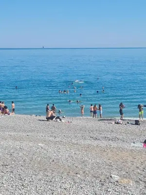 a group of people playing in the water at the beach at Royal Studio Massena in Nice