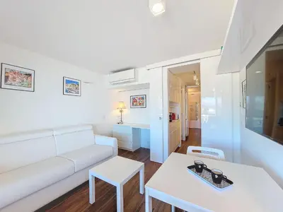 a living room with a white couch and a table at Nestor&Jeeves - BREAKTIME - Sea View - Parking in Nice