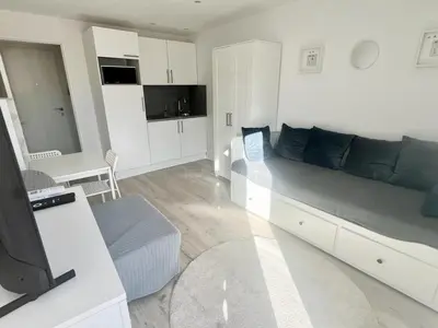 a living room with a large bed and a couch at Studio Moderne Rénové avec balcon in Nice