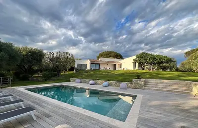 a backyard with a swimming pool and a house at Magnifique Villa Moderne Avec Piscine in La Gaude