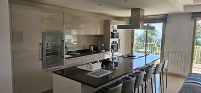 a kitchen with a large island with a counter top at bella d'azur in Nice