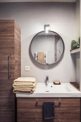 a bathroom with a sink and a mirror on the wall at Appartement in Carros
