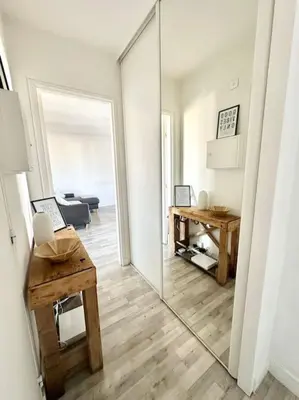 a kitchen with white cabinets and a washer and dryer at Joli 2 pièces - Proche aéroport - Terrasse vue mer in Nice