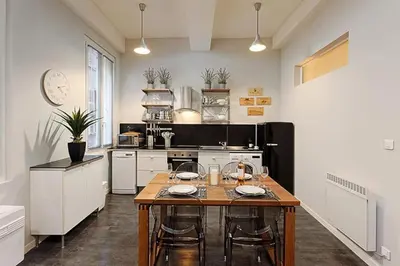 a kitchen with a table with chairs and a stove at #18 Rossetti Suite 2 Bedrooms , Central Old Nice/AC in Nice