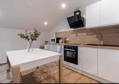 a kitchen with white cabinets and a white counter top at Trois pièces cozy n14 in Nice