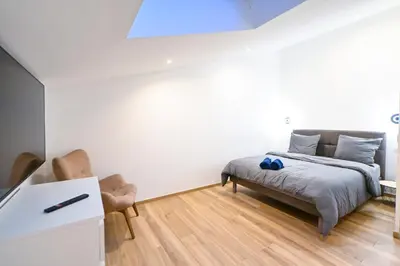 a bedroom with a bed and two chairs at Trois pièces cozy n14 in Nice