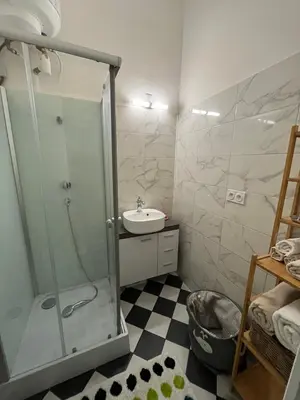 a bathroom with a glass shower and a sink at Appartement Nice Port Lympia Wifi Top Location in Nice