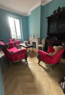 a living room with red chairs and a fireplace at Appartement Nice Port Lympia Wifi Top Location in Nice