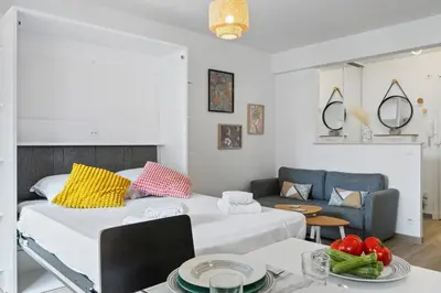 a living room with a bed and a couch at Le Mistral in Nice