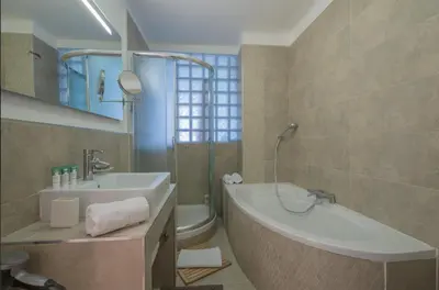 a bathroom with a tub and a sink and a toilet at Luxury apartment on Promenade des Anglais in Nice in Nice